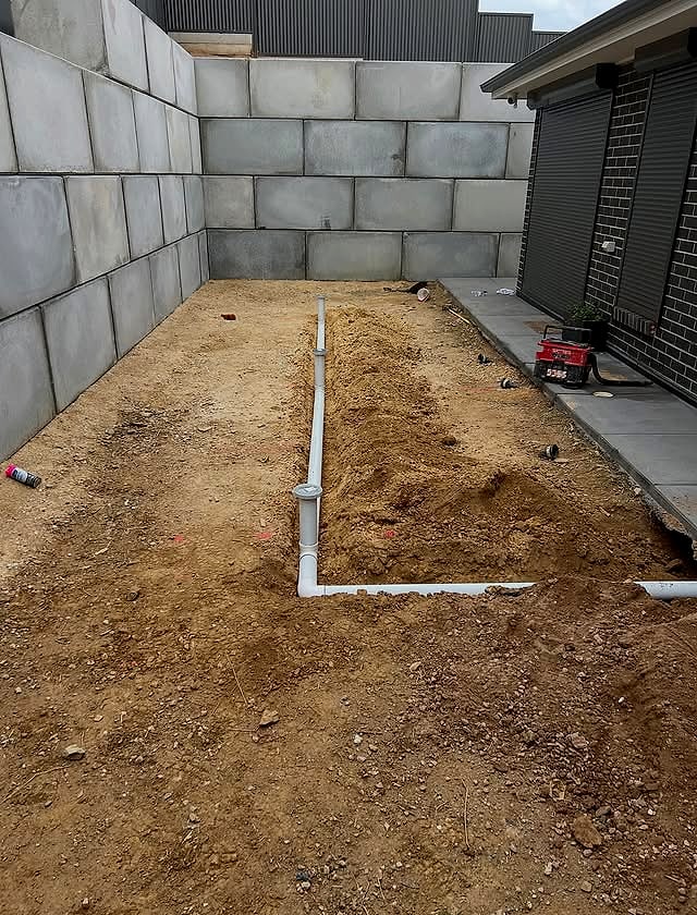 A new stormwater drainage system being installed across a graded building pad by Northern Stormwater Solutions