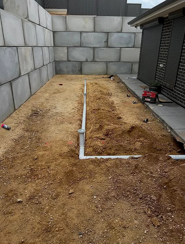 New stormwater drainage laid across a graded building pad