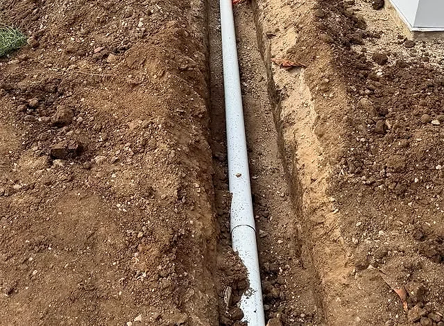 A stormwater drain being repaired in a trench
